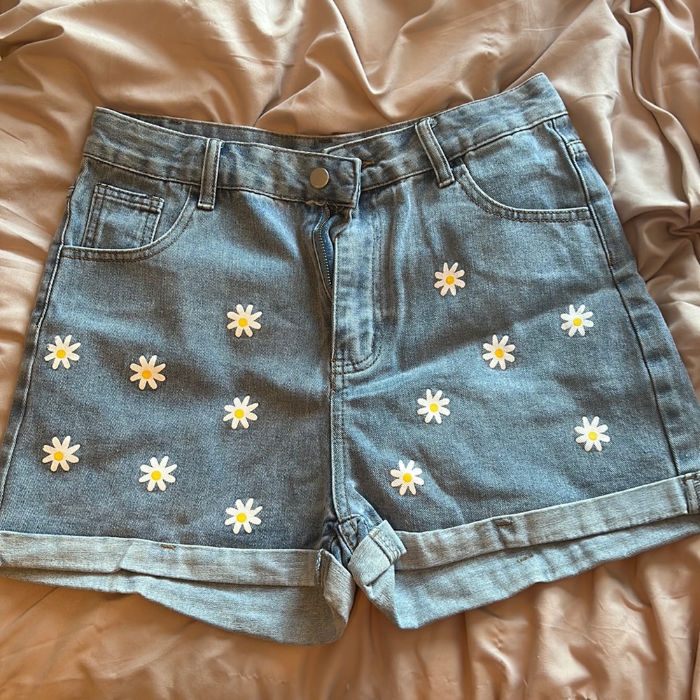 Light wash shorts with flowers on them